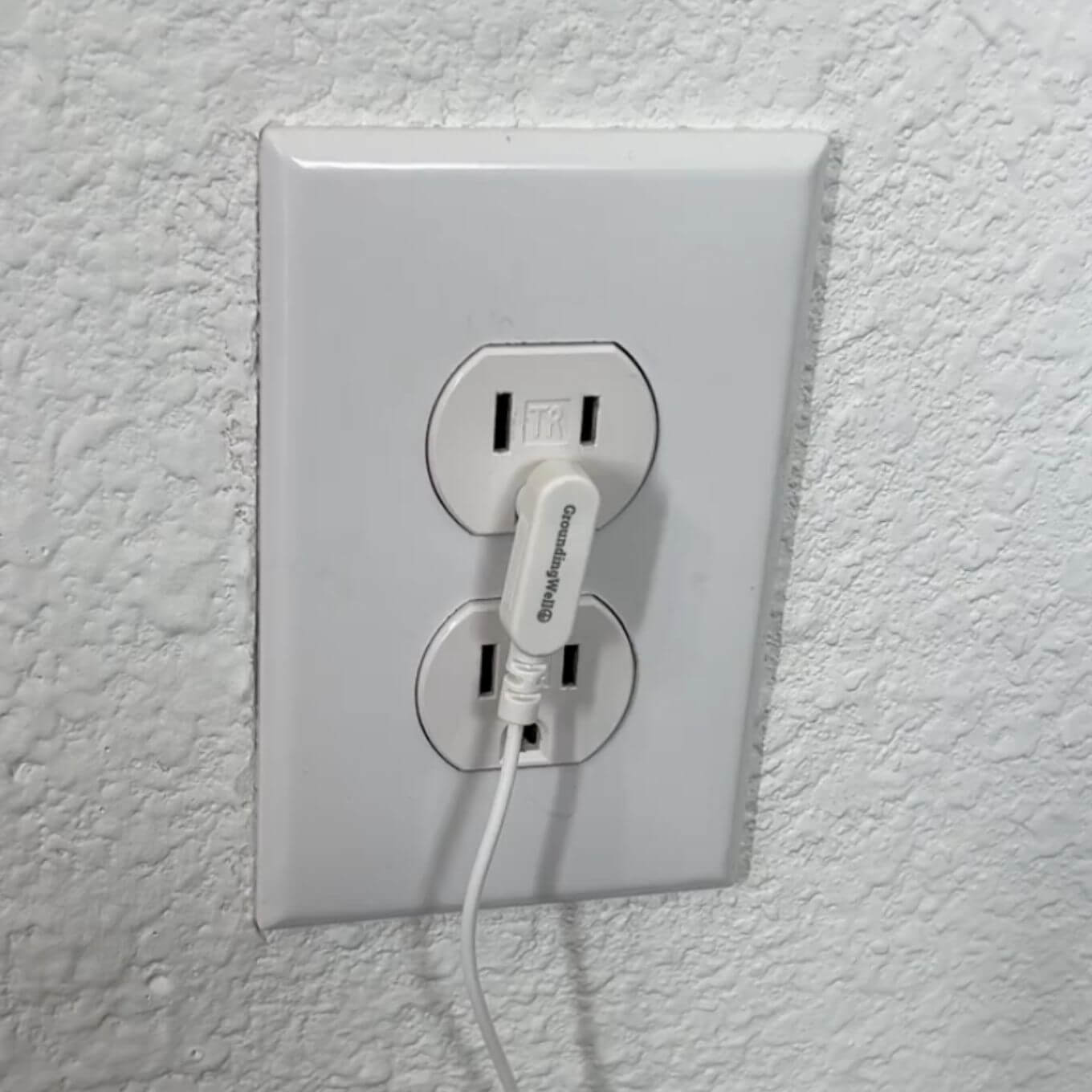 Grounding plug in wall outlet
